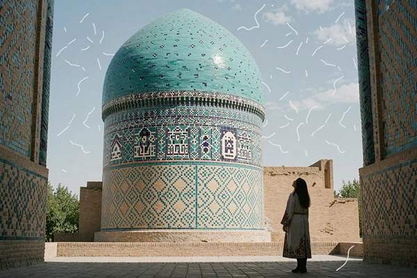 Uzbek woman standing beneath a turquoise-tiled dome and portal in Samarkand